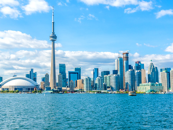 Image of the Toronto skyline along Lake Ontario, including the CN Tower and the Rogers Centre. 